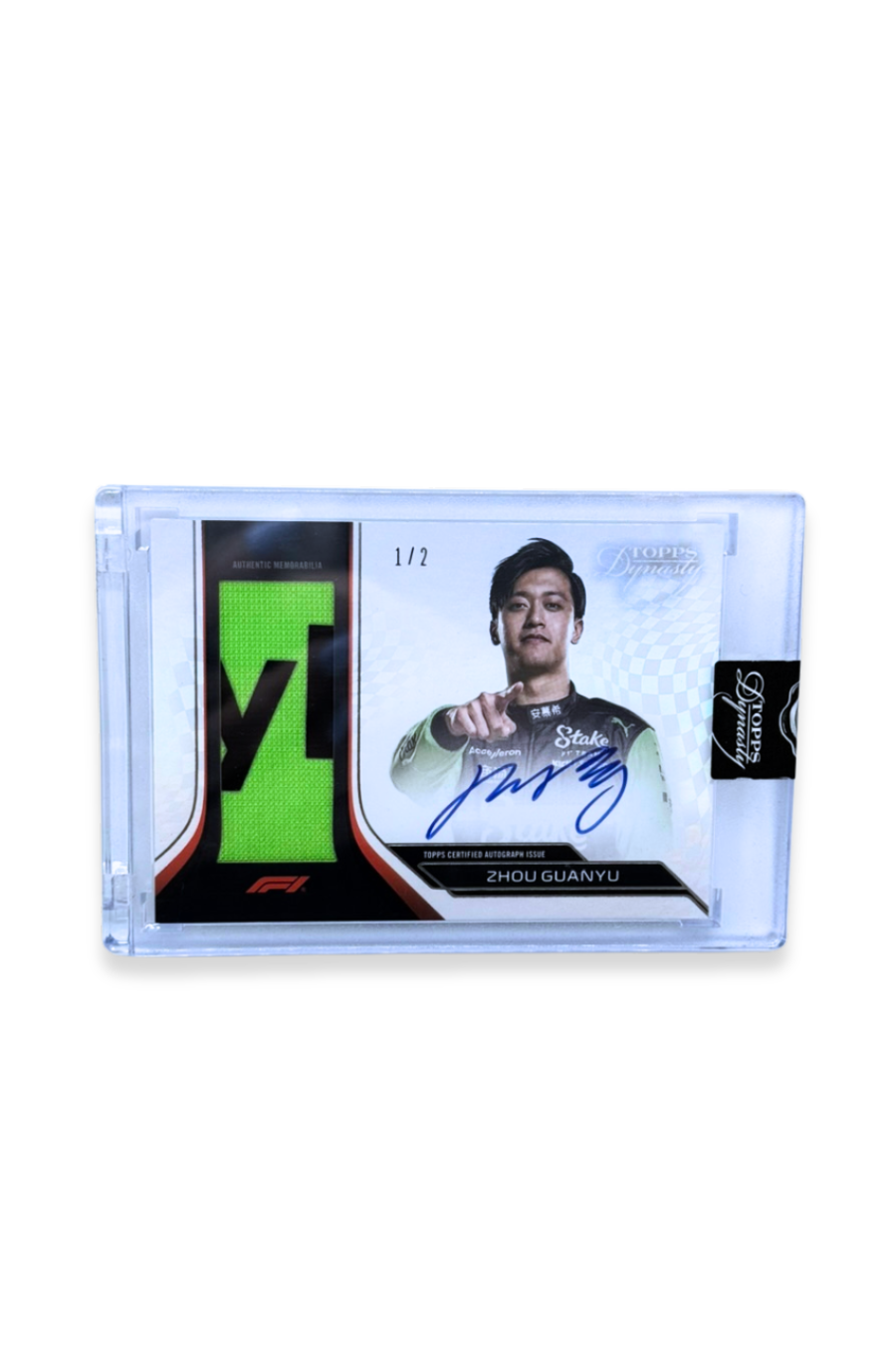 Front of 2024 Topps Dynasty Zhou Guanyu patch autograph card, serial numbered 1 of 2, with neon green memorabilia patch.