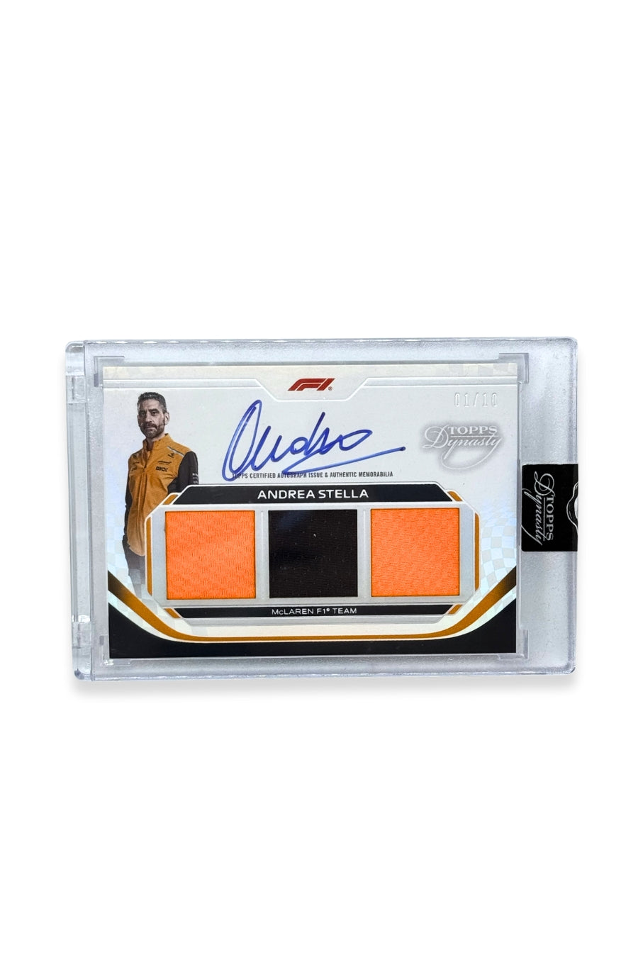 Front of 2024 Topps Dynasty Andrea Stella triple patch autograph card, serial numbered 1 of 10, featuring orange and black authentic memorabilia patches from McLaren F1 Team.