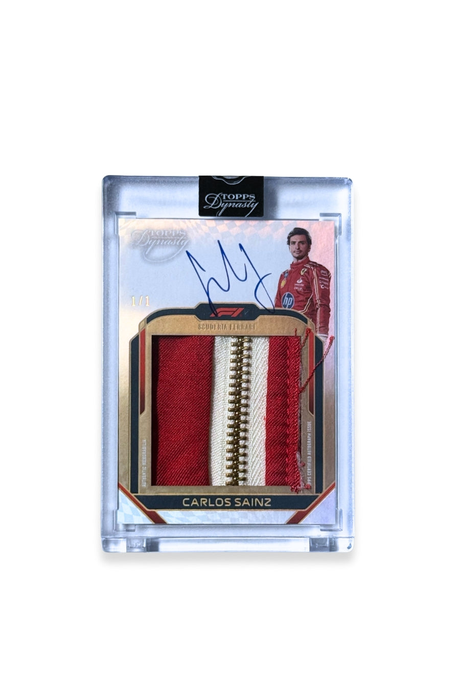 Front of 2024 Topps Dynasty Carlos Sainz jumbo zipper patch autograph card, serial numbered 1 of 1, with a red and white zipper memorabilia piece.