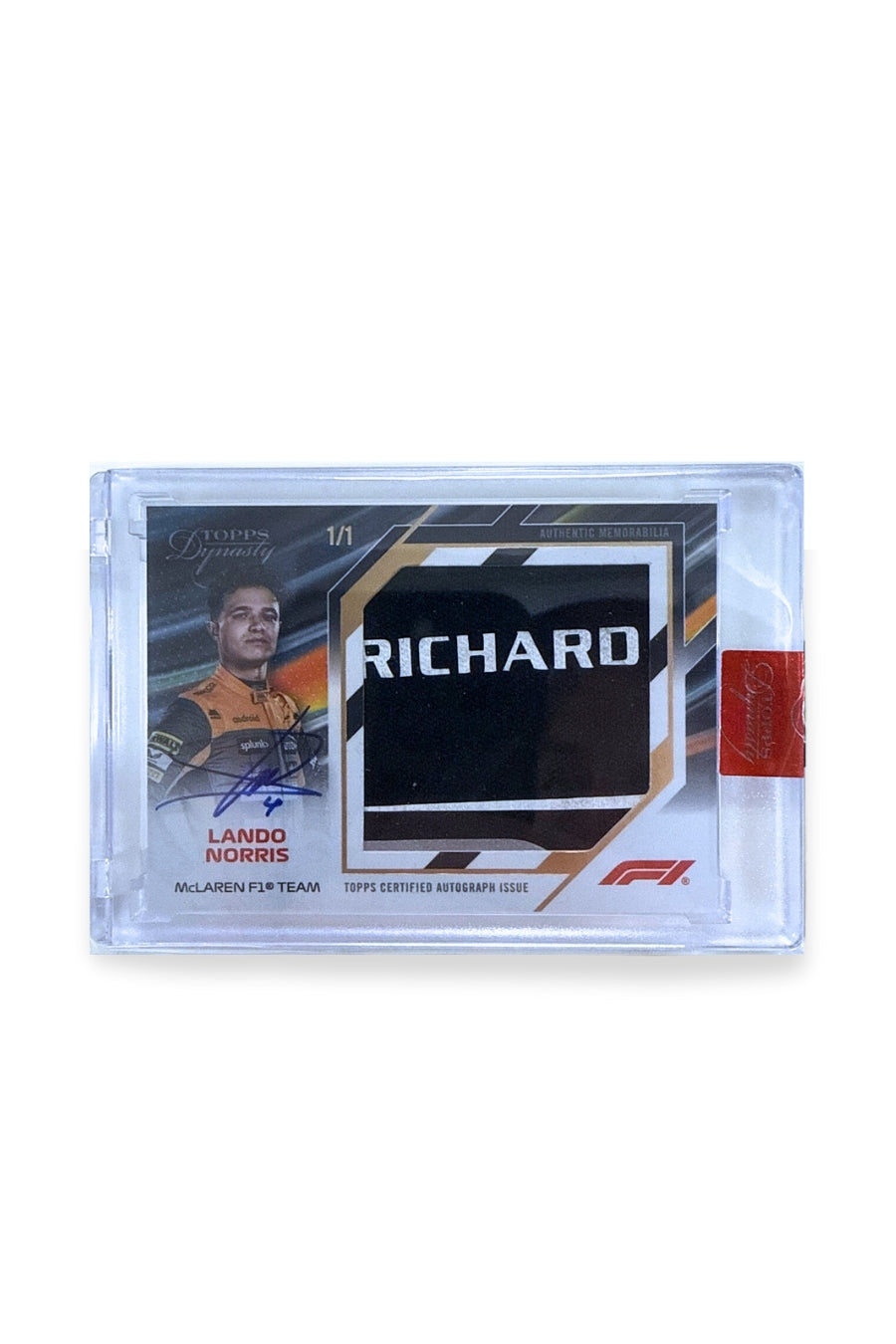 Front of 2024 Topps Dynasty Lando Norris jumbo nameplate letter patch autograph card, serial numbered 1 of 1, showing black patch with silver “RICHARD” lettering.
