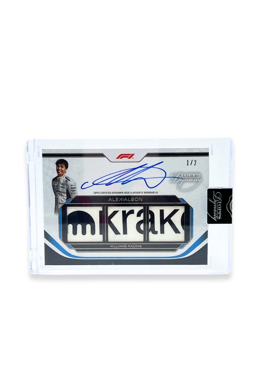Front of 2024 Topps Dynasty Alex Albon triple patch autograph card, serial numbered 1 of 2, featuring an authentic triple memorabilia patch showing part of the Kraken logo.