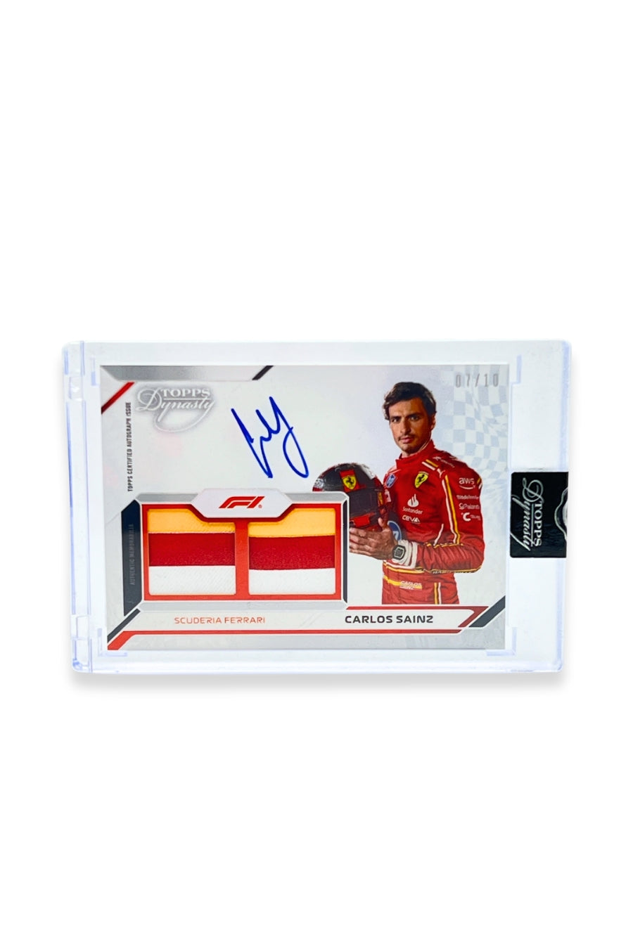 Front of 2024 Topps Dynasty Carlos Sainz double patch autograph card, serial numbered 7 of 10, featuring authentic red and white memorabilia patches.