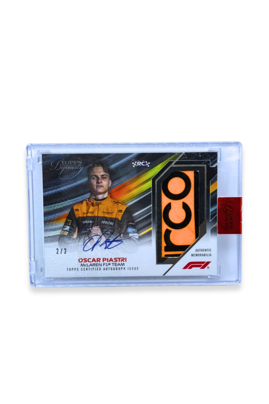 Front of 2023 Topps Dynasty Oscar Piastri rookie patch autograph card, serial numbered 2 of 2, showing McLaren orange memorabilia patch with âCOâ lettering and RC logo.
