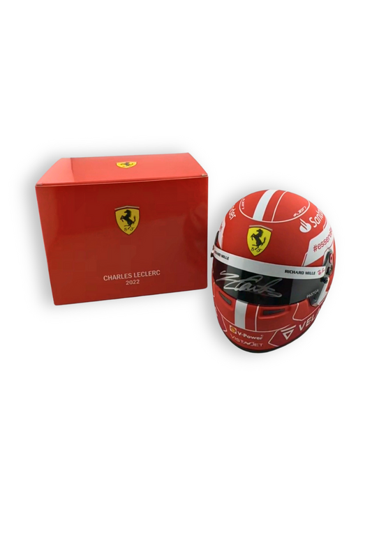 Charles Leclerc 2022 Ferrari helmet displayed next to original Ferrari red display box.