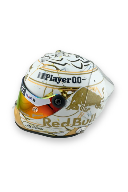 Alternate side view of Max Verstappen 2024 World Champion helmet, gold trim and sponsor logos visible.