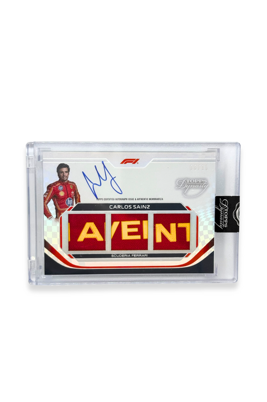 Front of 2024 Topps Dynasty Carlos Sainz triple patch F1 autograph card, serial numbered 8 of 10, showing red memorabilia patches with yellow lettering.
