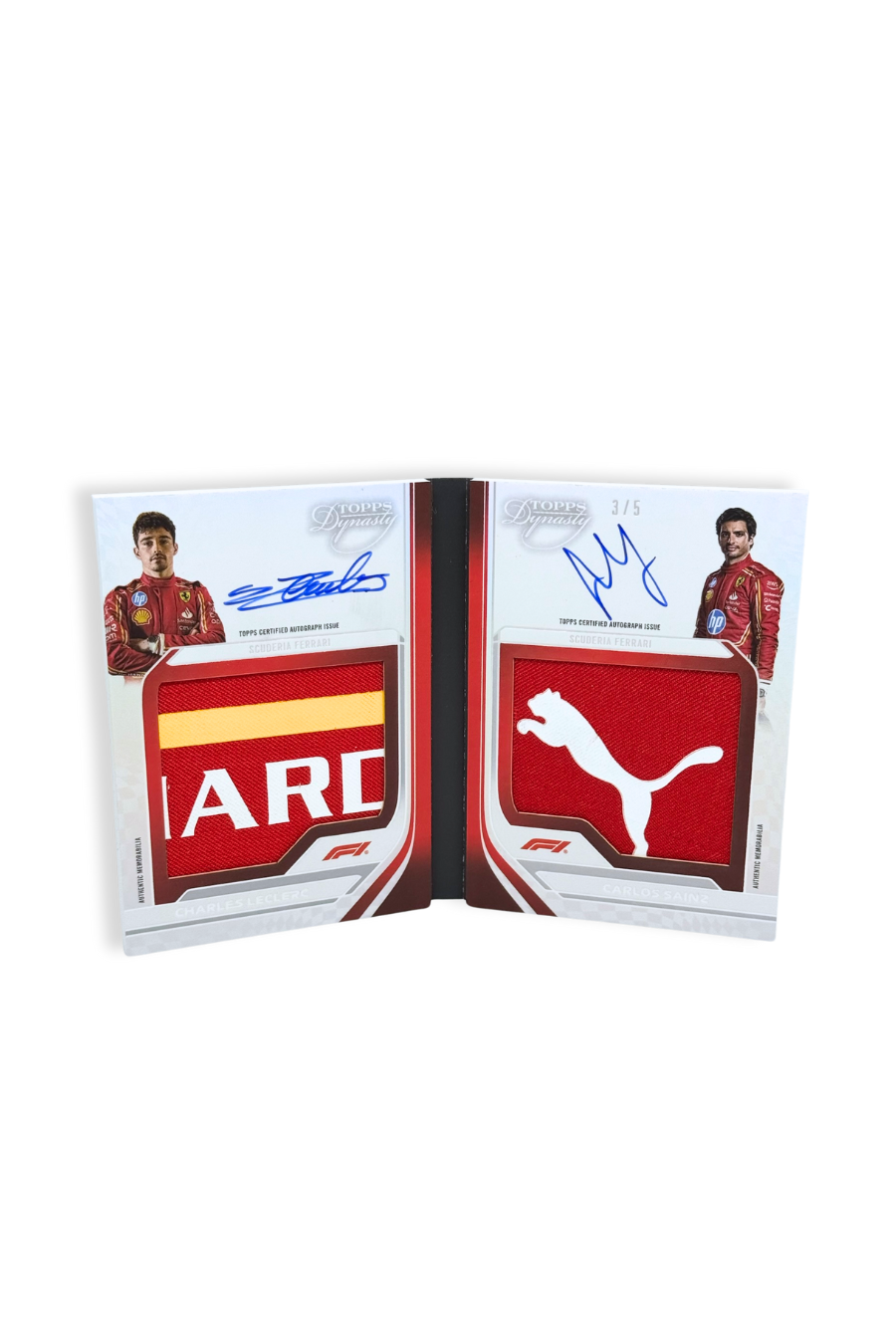 Open view of 2024 Topps Dynasty Charles Leclerc / Carlos Sainz booklet dual patch autograph card, serial numbered 3 of 5, showing red and yellow patch on Leclerc side and white Puma logo patch on Sainz side.