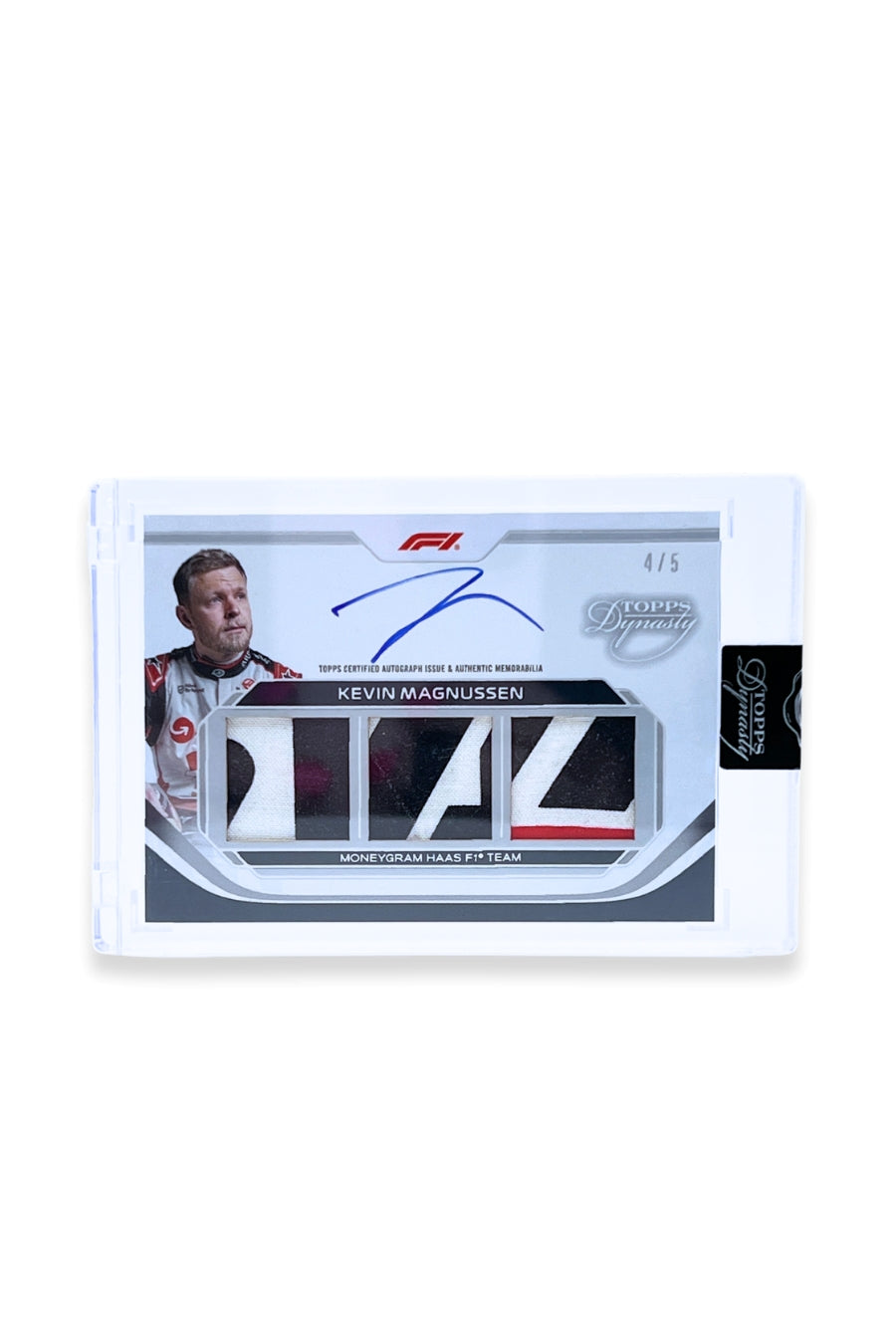 Front of 2024 Topps Dynasty Kevin Magnussen triple patch autograph card, serial numbered 4 of 5, featuring white, black, and red authentic memorabilia patches from MoneyGram Haas F1 Team.
