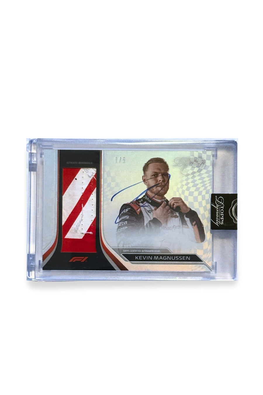 Front of 2024 Topps Dynasty Kevin Magnussen patch autograph F1 card, serial numbered 1 of 5, showing red and white diagonal stripe memorabilia patch.