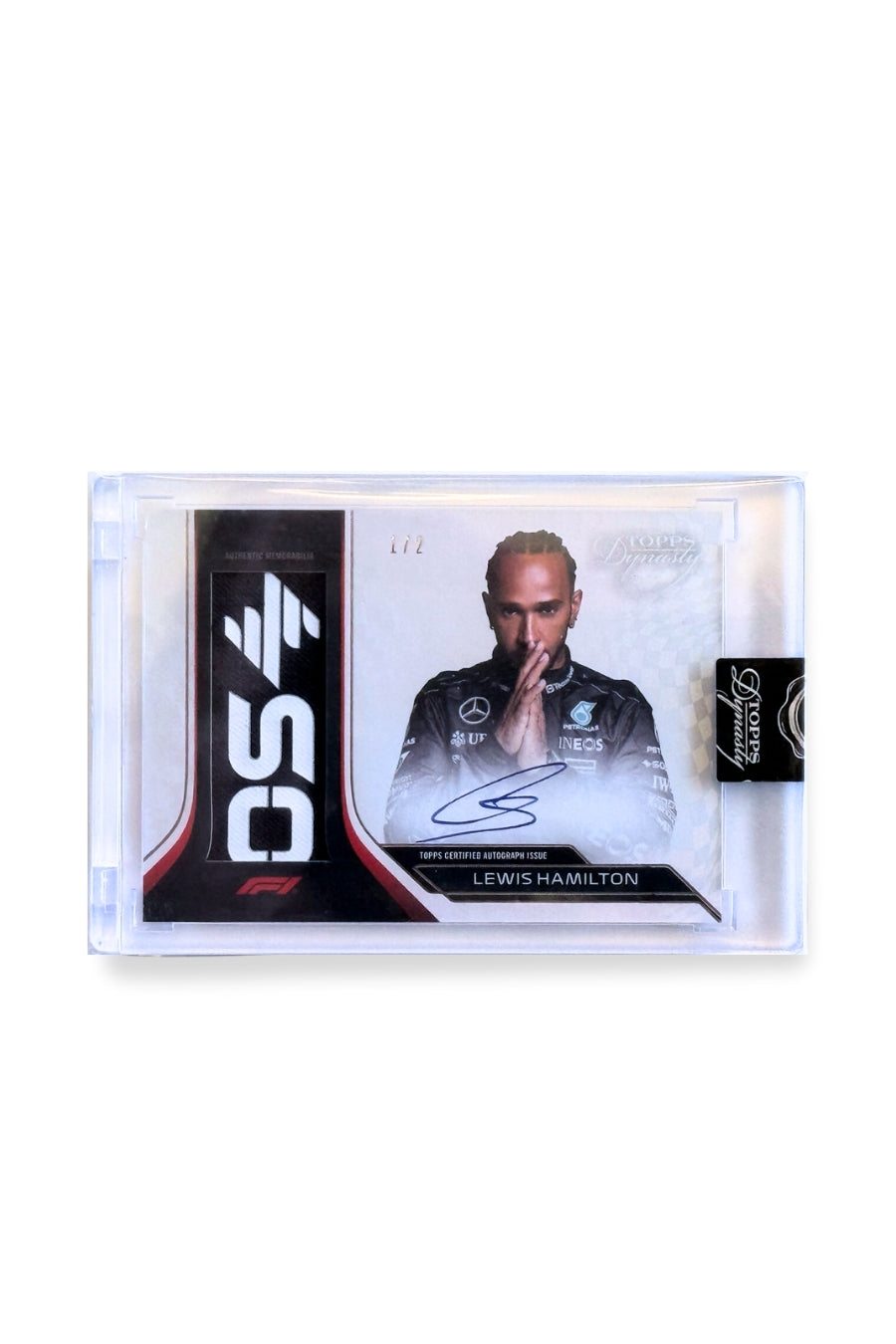 Front of 2024 Topps Dynasty Lewis Hamilton patch autograph card, serial numbered 1 of 2, showing black and white memorabilia patch with “OS” lettering detail.