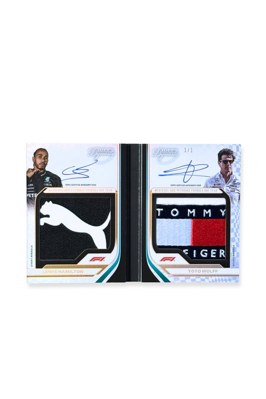 Front of 2024 Topps Dynasty booklet showing Lewis Hamilton and Toto Wolff patch autograph card, serial numbered 1 of 1, with Puma logo patch and Tommy Hilfiger logo patch.