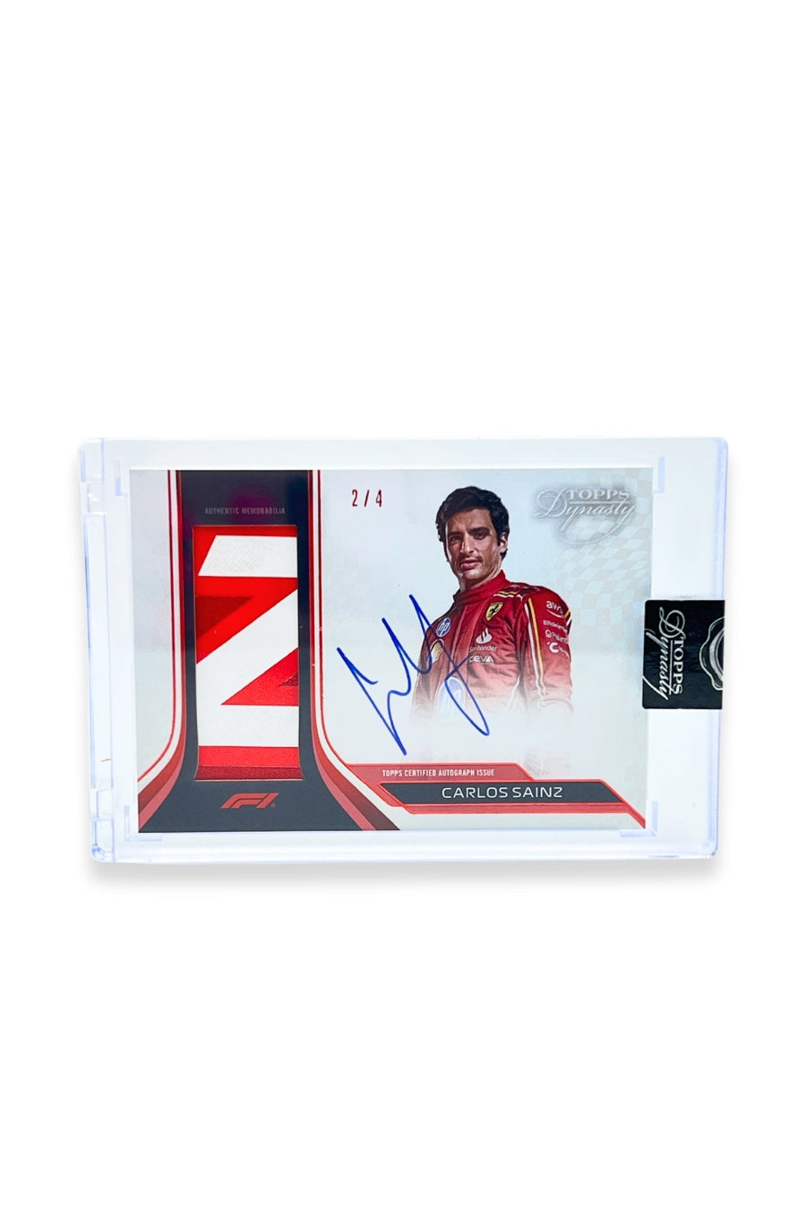 Front of 2024 Topps Dynasty Carlos Sainz patch autograph card, serial numbered 2 of 4, featuring an authentic red and white angled stripe memorabilia patch.