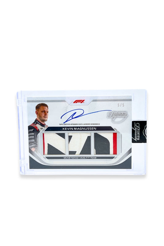 Front of 2024 Topps Dynasty Kevin Magnussen triple patch autograph card, serial numbered 5 of 5, featuring an authentic triple memorabilia patch in white, black, and red.