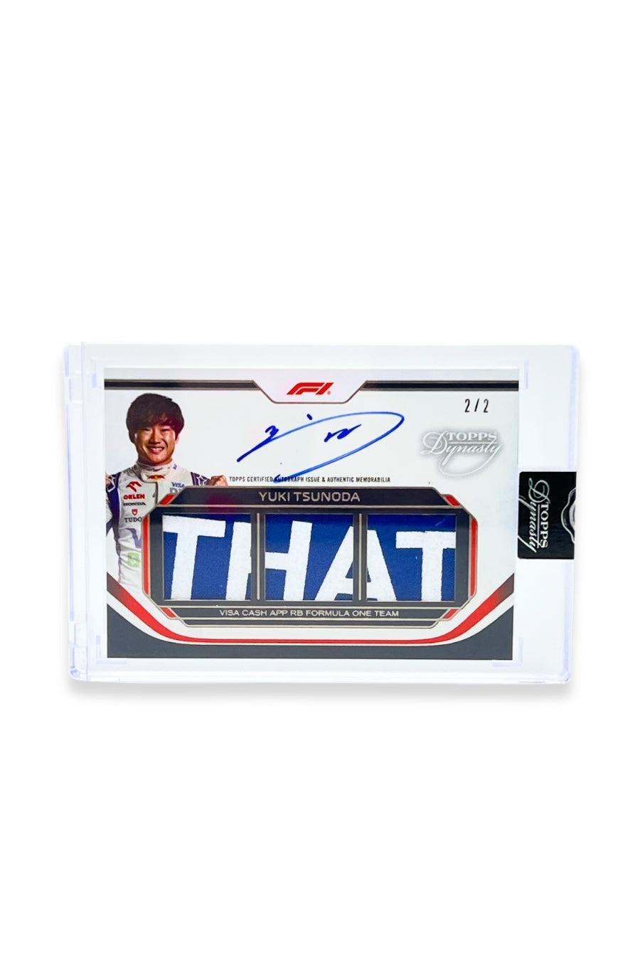 Front of 2024 Topps Dynasty Yuki Tsunoda triple patch autograph card, serial numbered 2 of 2, featuring an authentic triple memorabilia patch with the word “THAT.”
