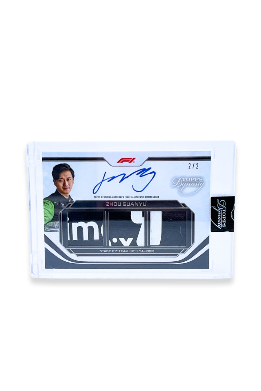 Front of 2024 Topps Dynasty Zhou Guanyu triple patch autograph card, serial numbered 2 of 2, featuring navy and white memorabilia patches with visible lettering.