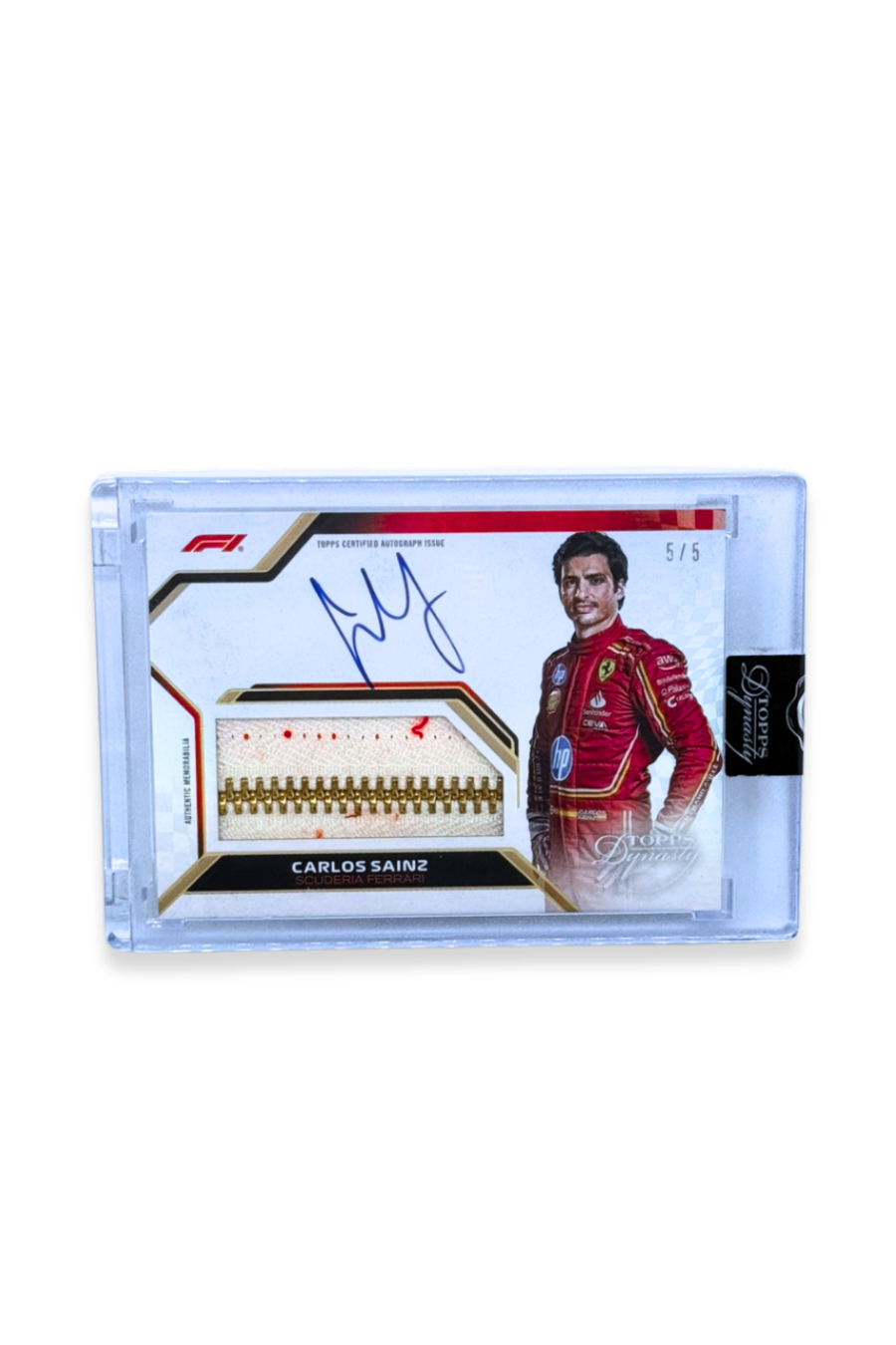 Front of 2024 Topps Dynasty Carlos Sainz zipper patch autograph card, serial numbered 5/5, with gold zipper and Ferrari suit design