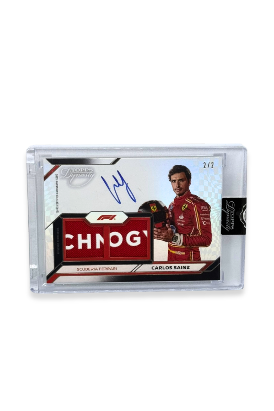 Front of 2024 Topps Dynasty Carlos Sainz logo patch autograph card, serial numbered 2 of 2, featuring red and white Ferrari memorabilia patch.