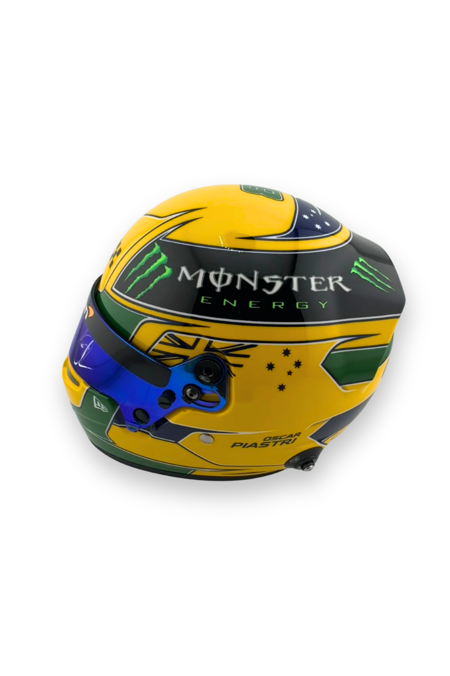 Left side view of Oscar Piastri 2023 Australian GP replica helmet featuring McLaren, Monster Energy, and sponsor branding